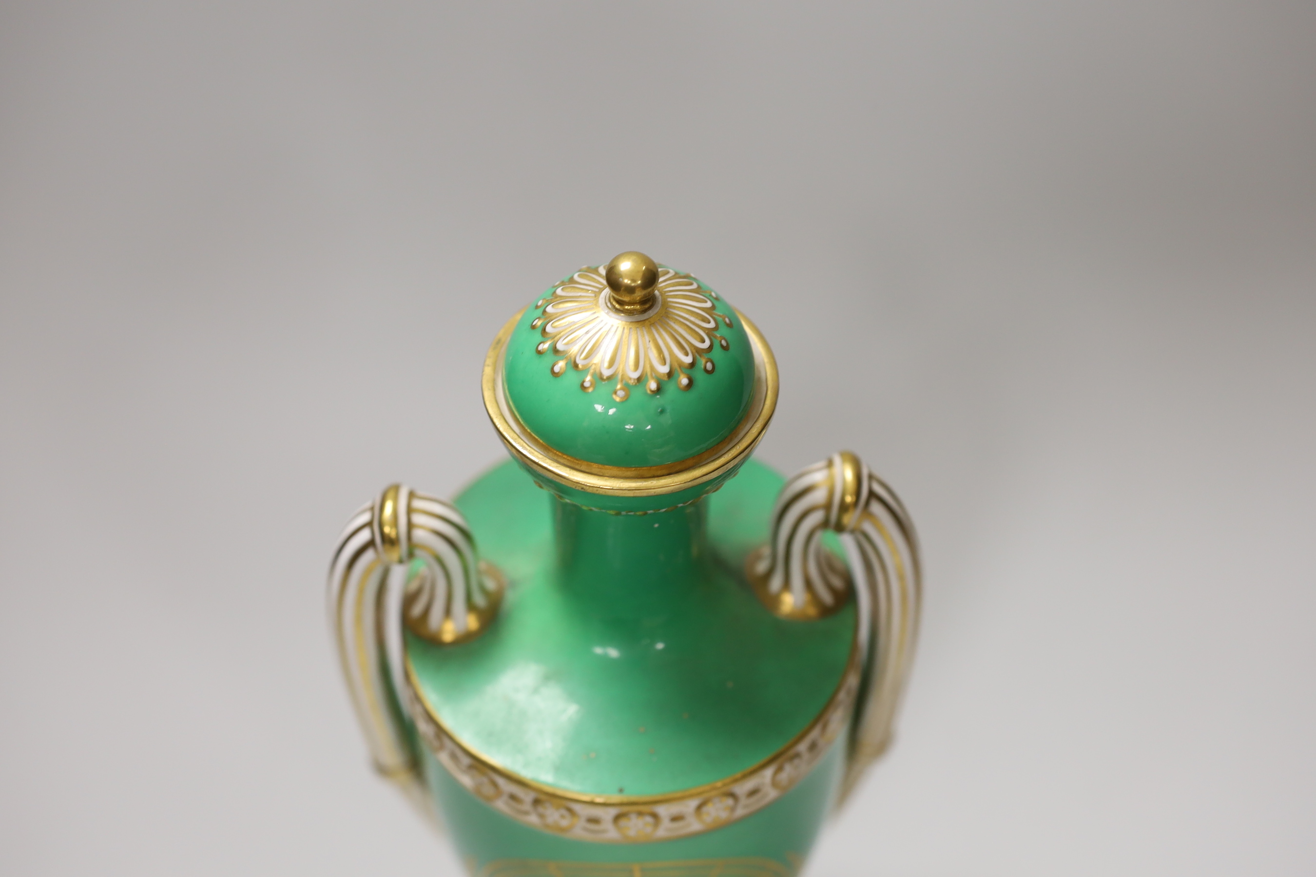 A Coalport two handled green ground vase and cover painted with a landscape, verso with fruit by Cook, 28cm high